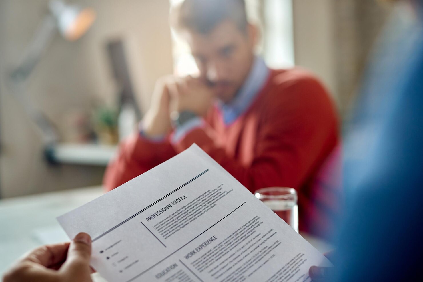 closeup-member-human-resource-teal-reading-candidate-s-cv-meeting-office_637285-6913